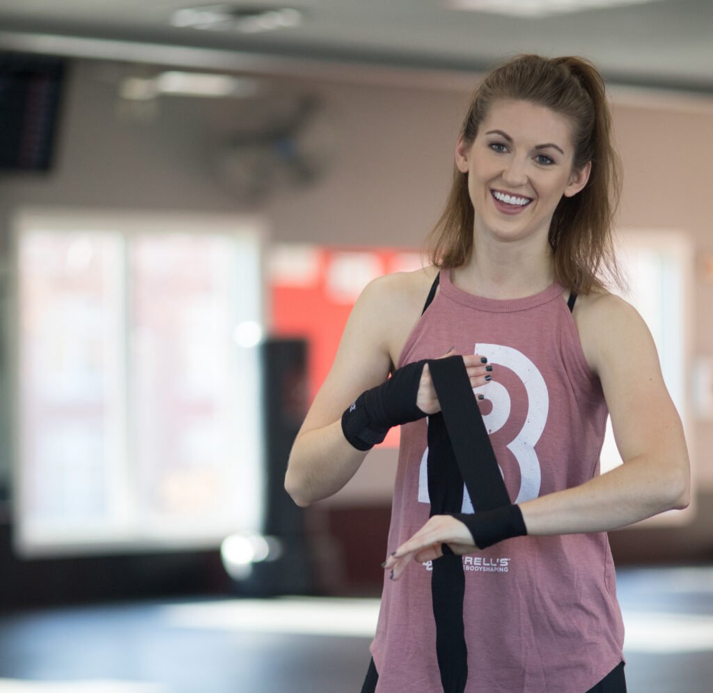 Woman wrapping hands for kickboxing class